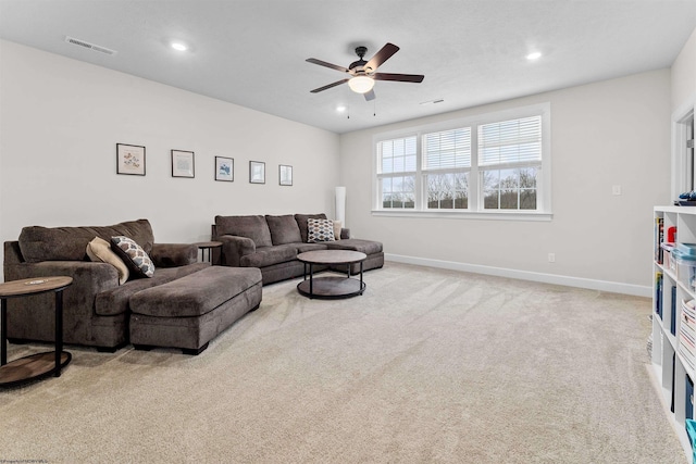 living room with ceiling fan and light colored carpet