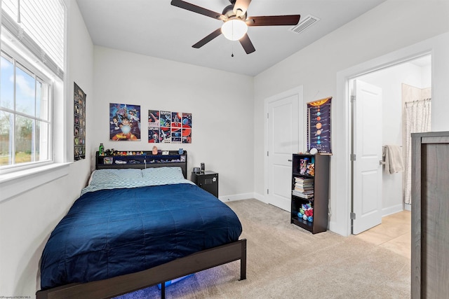 bedroom with ceiling fan and light carpet