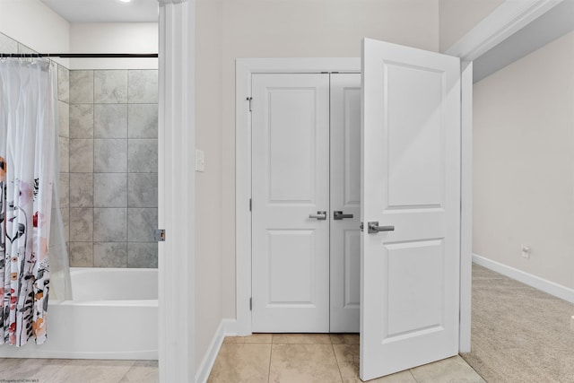 bathroom with tile patterned floors and shower / bathtub combination with curtain