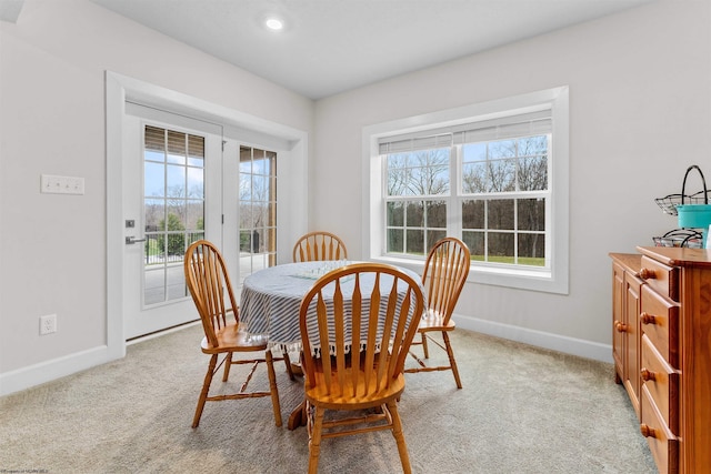 dining space with light carpet and a wealth of natural light