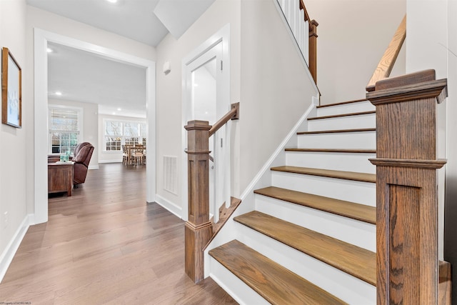 stairs with hardwood / wood-style floors