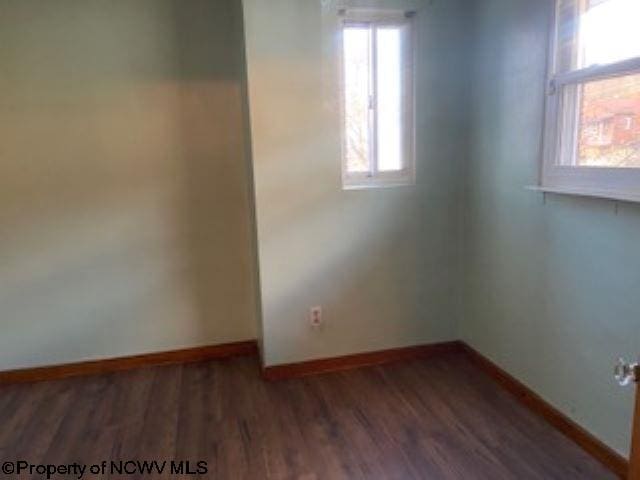 unfurnished room featuring dark hardwood / wood-style flooring