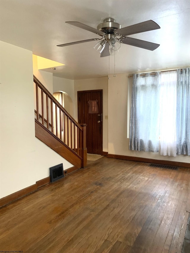 interior space featuring ceiling fan and dark wood-type flooring