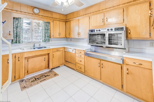 kitchen with dishwasher, sink, decorative backsplash, light tile patterned floors, and wall oven