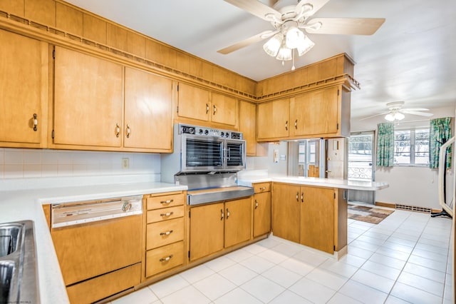 kitchen with ceiling fan, paneled dishwasher, kitchen peninsula, and light tile patterned floors