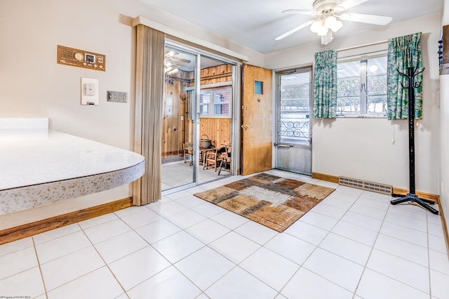 entryway with ceiling fan and light tile patterned flooring