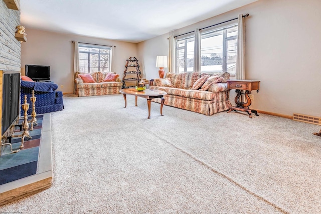 carpeted living room with a brick fireplace