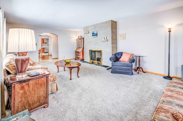 living room with a fireplace and light colored carpet