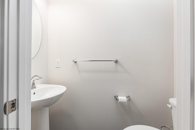 bathroom featuring sink and toilet