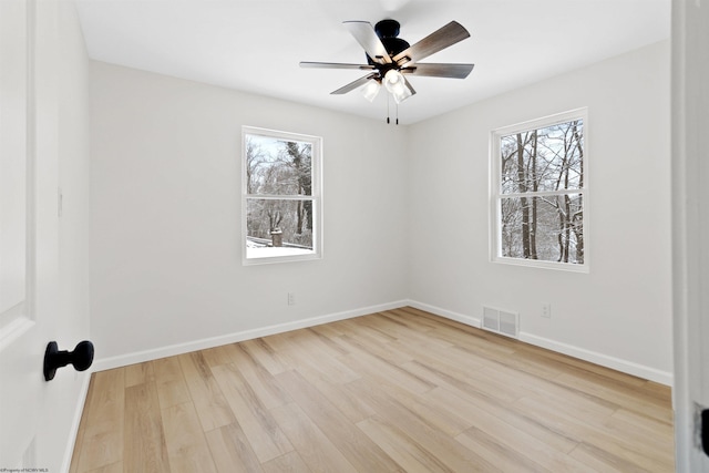 spare room featuring ceiling fan and light hardwood / wood-style floors