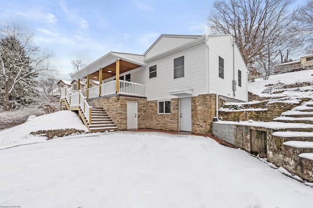 view of snowy exterior with a balcony