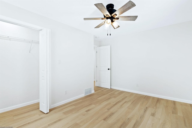 unfurnished bedroom with ceiling fan, a closet, and light hardwood / wood-style floors