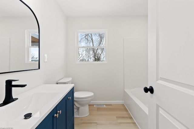 bathroom featuring hardwood / wood-style floors, vanity, and toilet