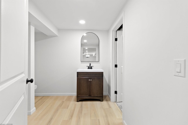 hallway featuring light hardwood / wood-style flooring and sink