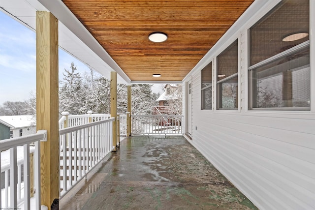 snow covered patio with covered porch