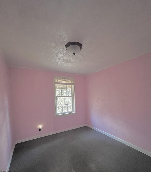 carpeted spare room with a textured ceiling