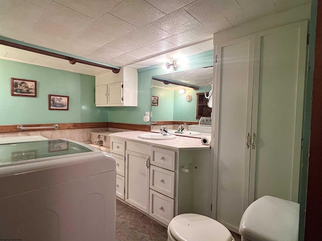 bathroom with tile patterned flooring, vanity, and toilet