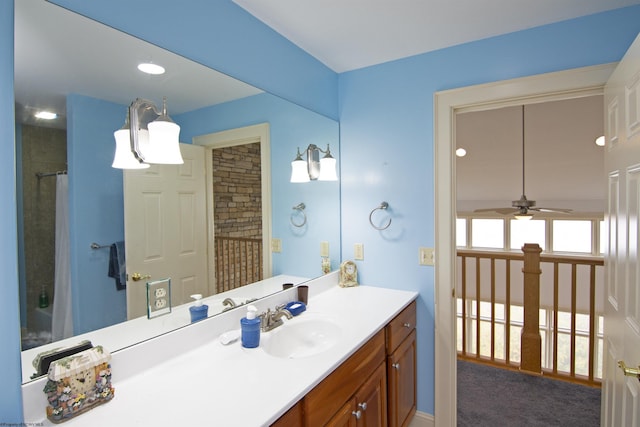 bathroom featuring a shower with curtain, ceiling fan, and vanity