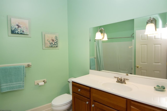 bathroom with vanity, toilet, and walk in shower