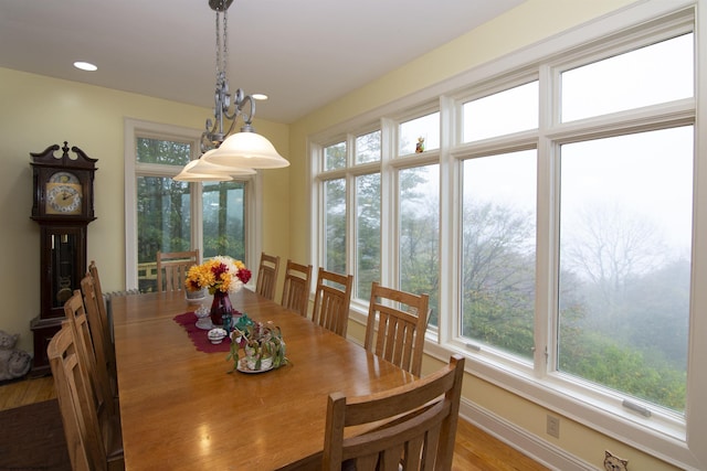 dining area featuring light hardwood / wood-style floors and an inviting chandelier