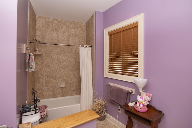 bathroom featuring shower / bath combo with shower curtain