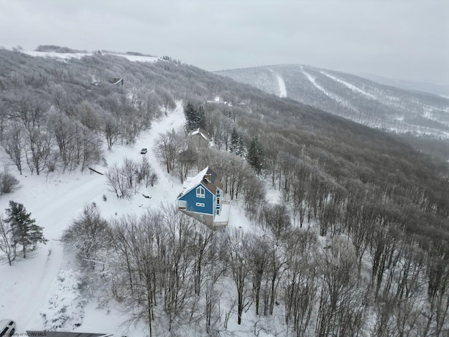 snowy aerial view with a mountain view