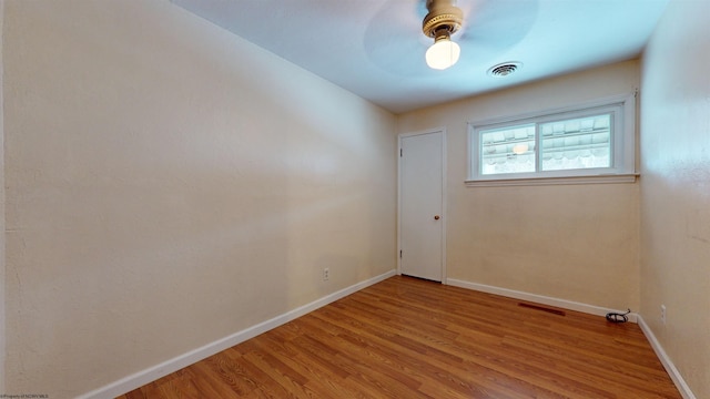 empty room featuring ceiling fan and light hardwood / wood-style flooring