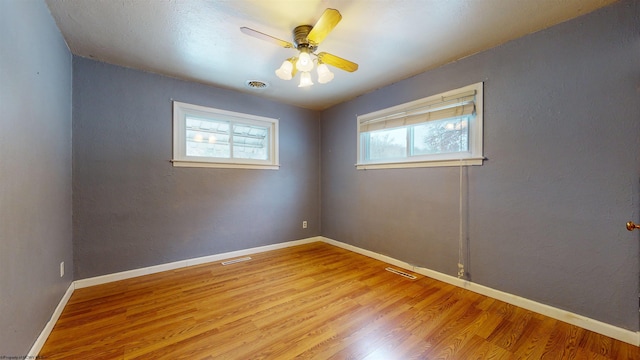 unfurnished room with ceiling fan and light hardwood / wood-style floors