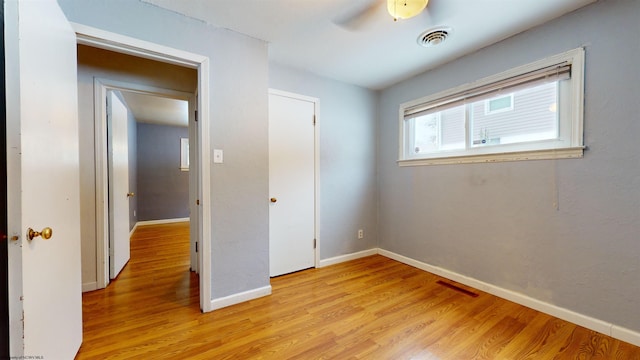 unfurnished bedroom featuring ceiling fan and light hardwood / wood-style flooring