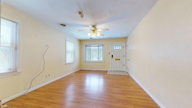 interior space featuring a wealth of natural light, light hardwood / wood-style floors, and ceiling fan