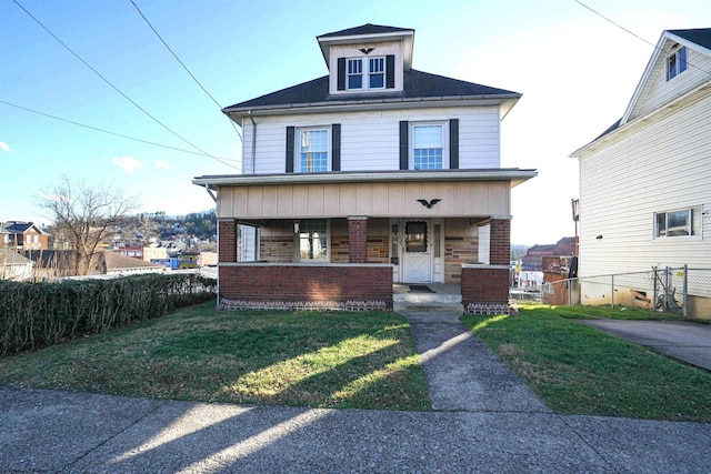 view of front of property with covered porch and a front yard