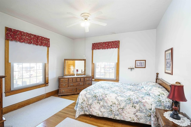 bedroom with light hardwood / wood-style floors and ceiling fan