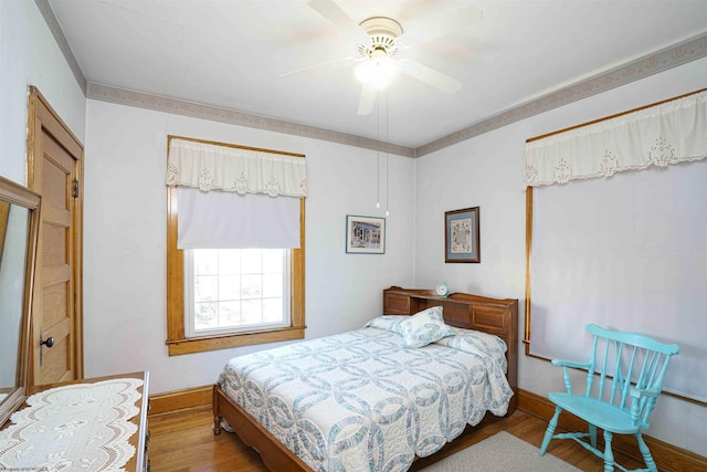 bedroom with ceiling fan and wood-type flooring