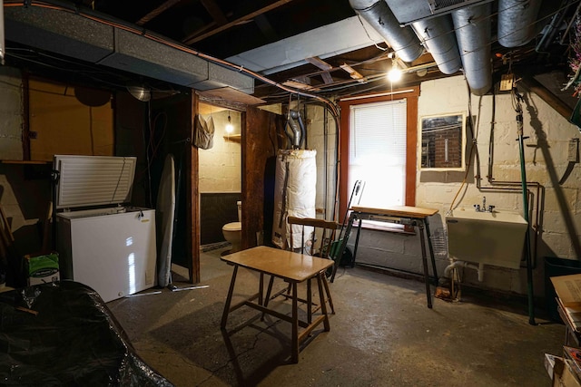 basement with sink and gas water heater