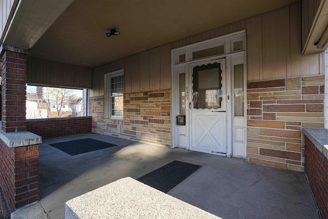 view of exterior entry with covered porch