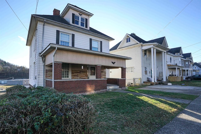 view of front of house with covered porch and a front yard