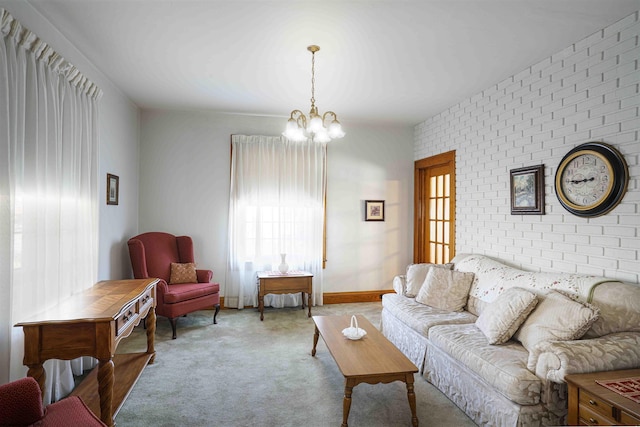 living room with light colored carpet, a notable chandelier, and brick wall