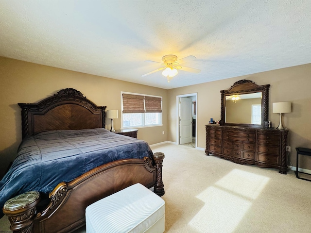 carpeted bedroom featuring ceiling fan and a textured ceiling