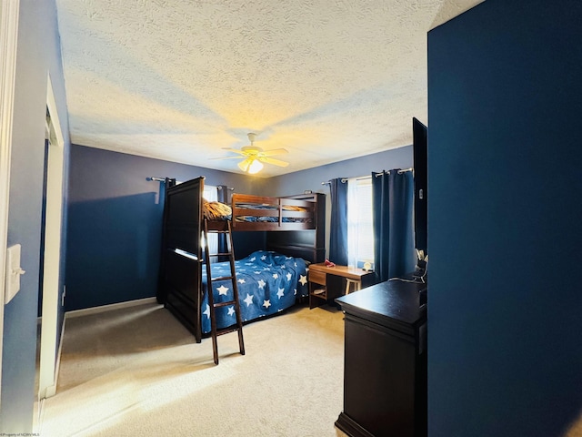 bedroom featuring ceiling fan, carpet floors, and a textured ceiling