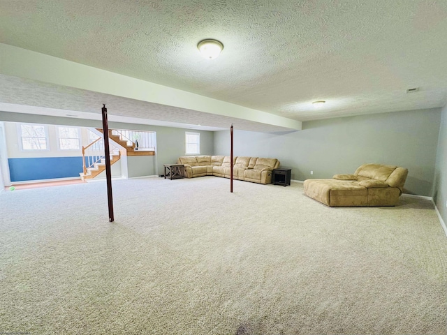 basement with a healthy amount of sunlight, carpet floors, and a textured ceiling