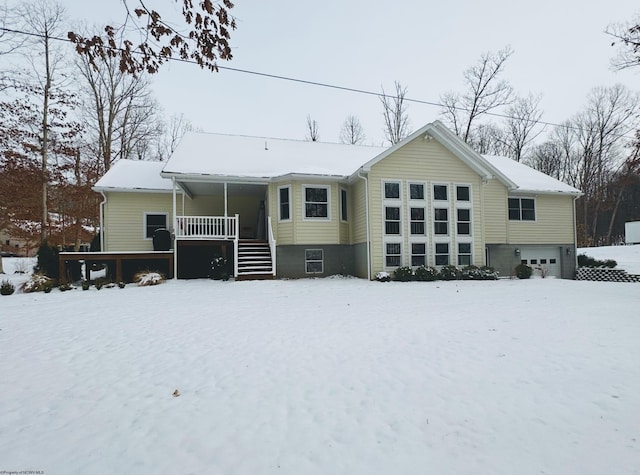 snow covered property featuring covered porch