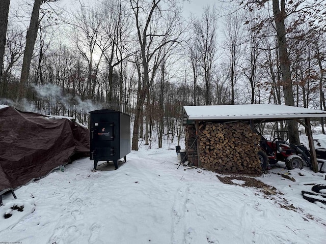 yard layered in snow with a carport