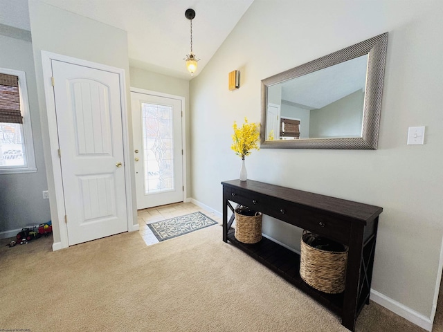 foyer featuring light carpet and lofted ceiling