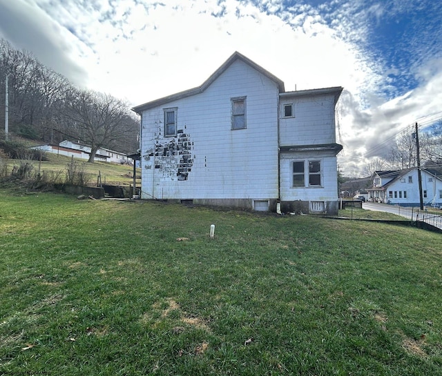 rear view of house with a yard