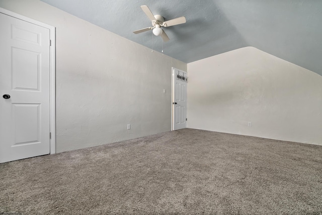 spare room with carpet, vaulted ceiling, and ceiling fan