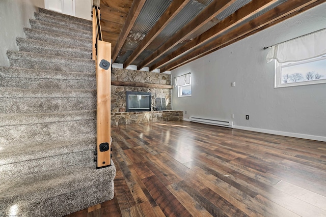 unfurnished living room with beamed ceiling, wood-type flooring, and a baseboard radiator