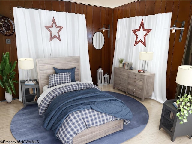 bedroom featuring wood walls and light wood-type flooring