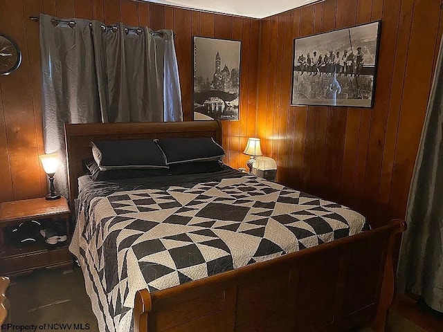 bedroom with carpet and wooden walls