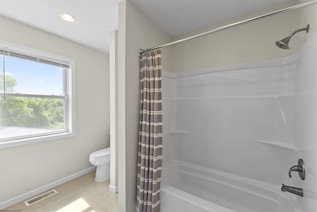 bathroom with toilet and shower / tub combo with curtain