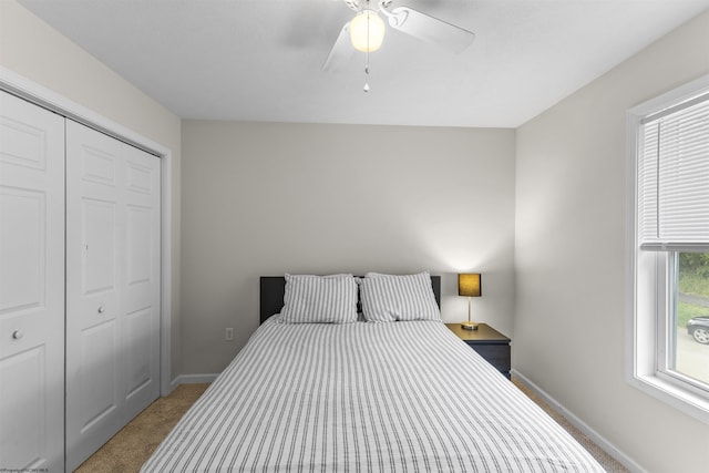 carpeted bedroom with a closet and ceiling fan